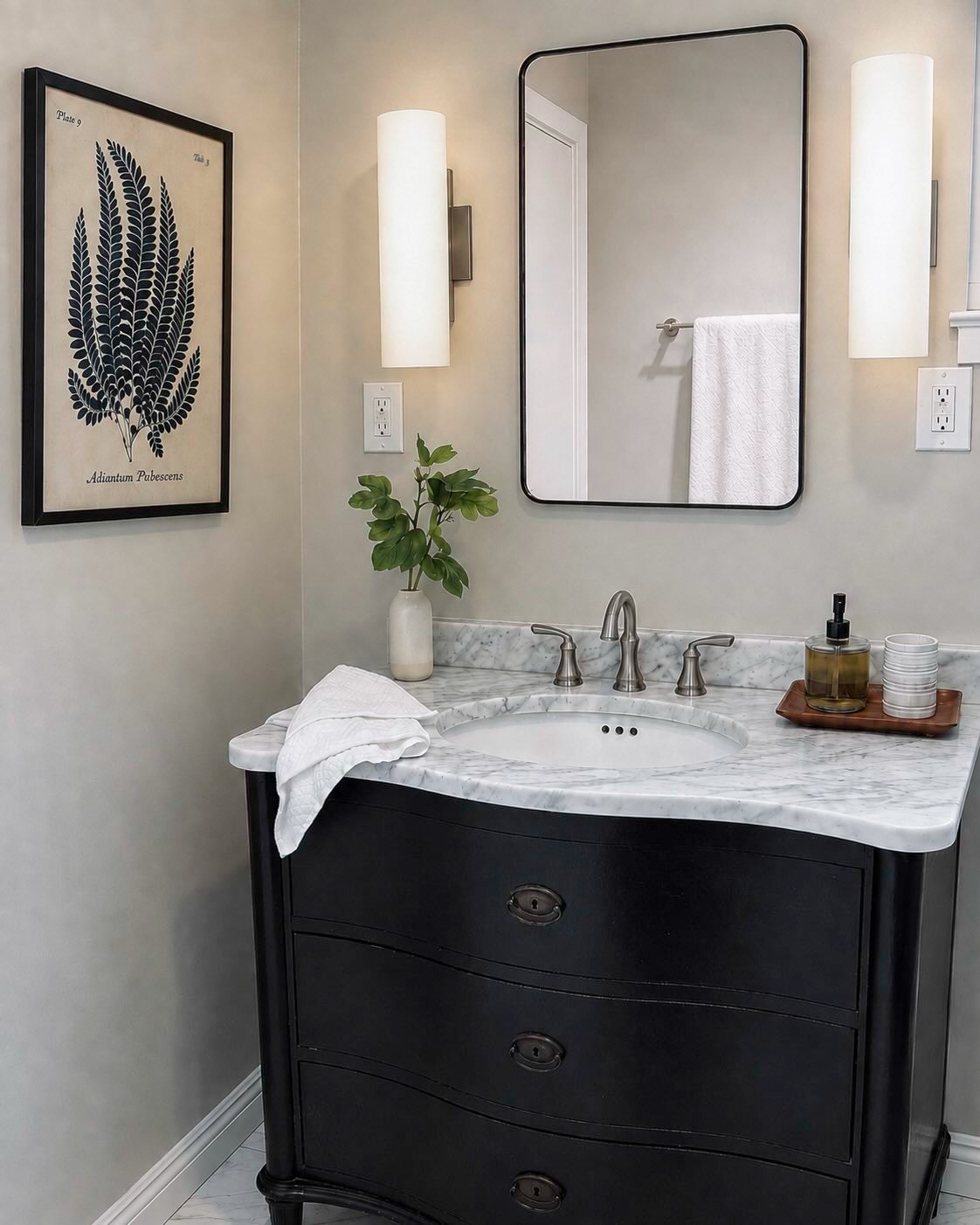 Staged powder room with marble vanity and botanical print, San Carlos
