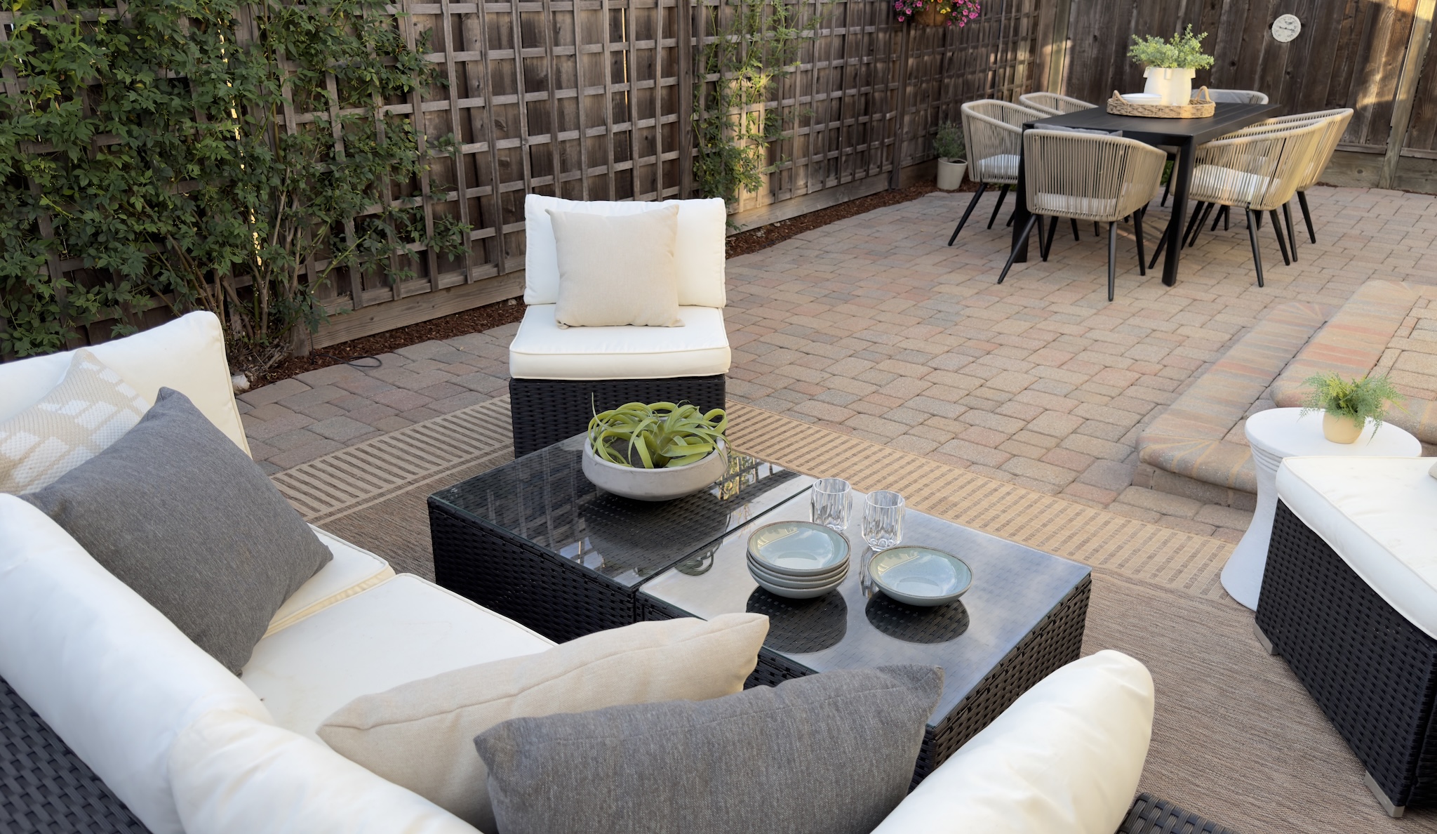 Patio with outdoor sofa, coffee table and dining set