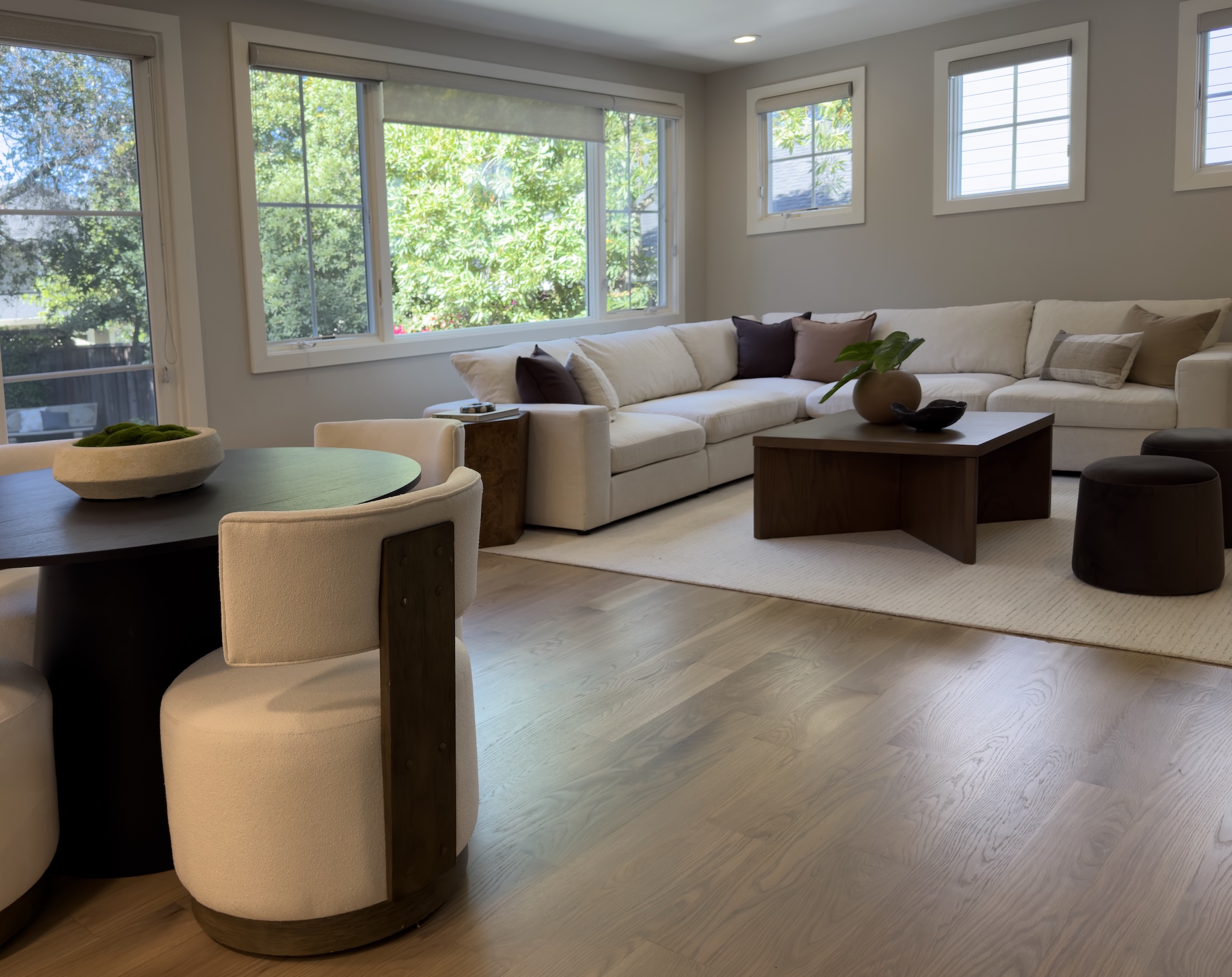 Family room with sectional and swivel chair by the windows