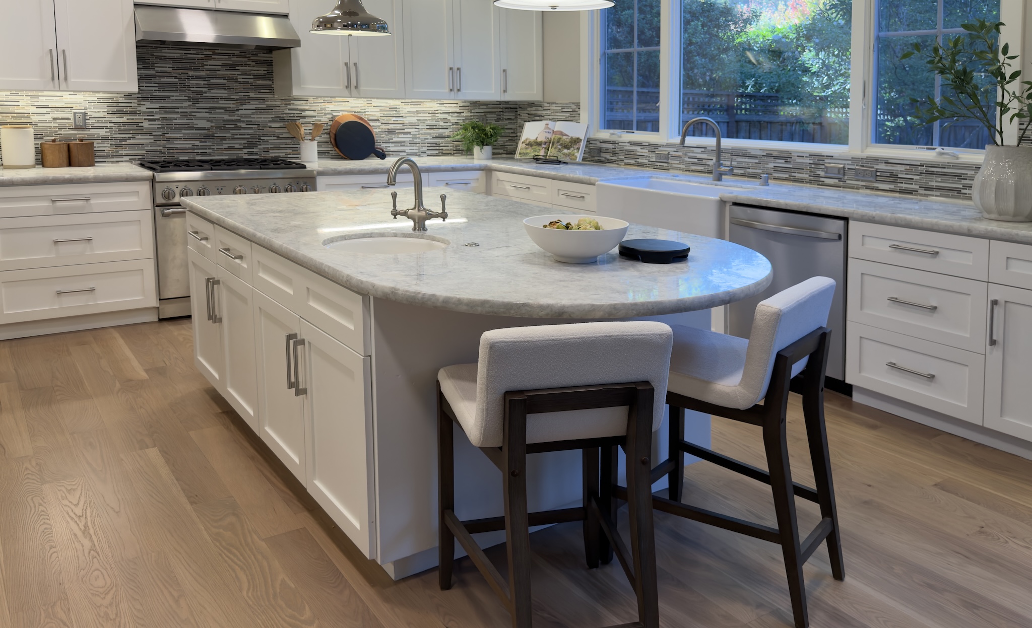 Kitchen with marble island and counter stools
